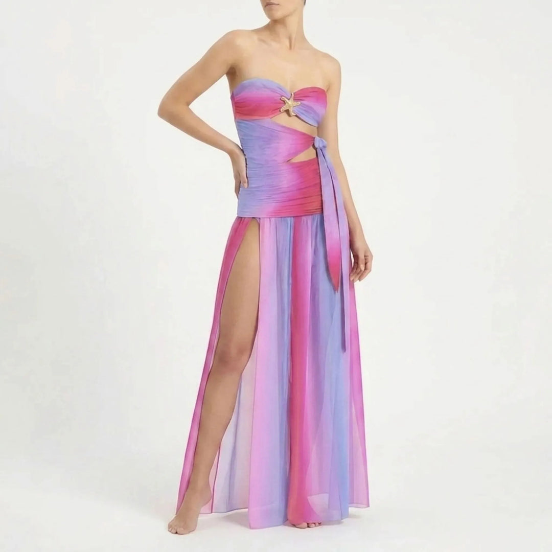 Chic women's cutout swimwear with a long flowing skirt, perfect for resort holidays.