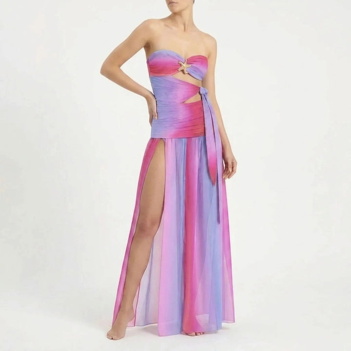 Chic women's cutout swimwear with a long flowing skirt, perfect for resort holidays.