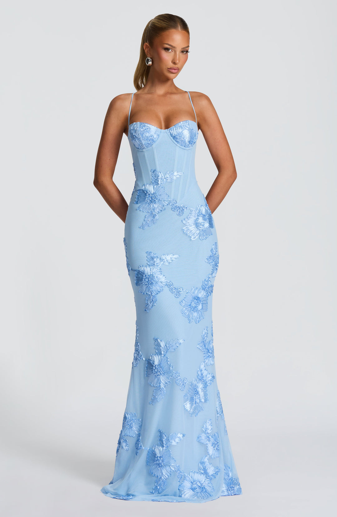 Detailed view of the structured corset bodice & delicate floral appliqué on a formal mermaid maxi dress.