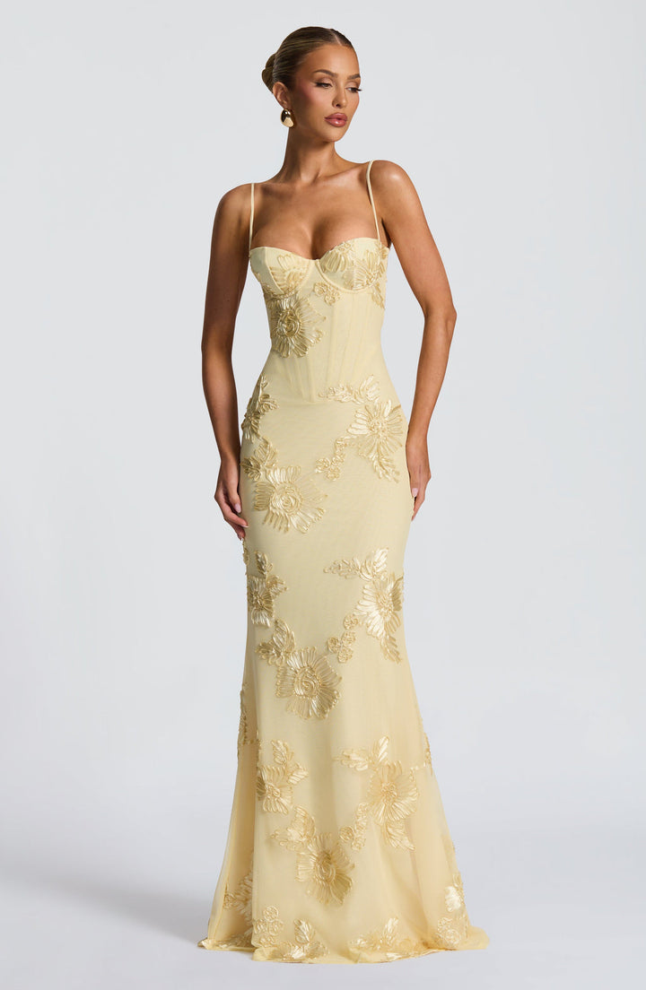 Stunning yellow floral appliqué corset mermaid formal maxi dress with spaghetti straps. Ideal prom or wedding guest gown.