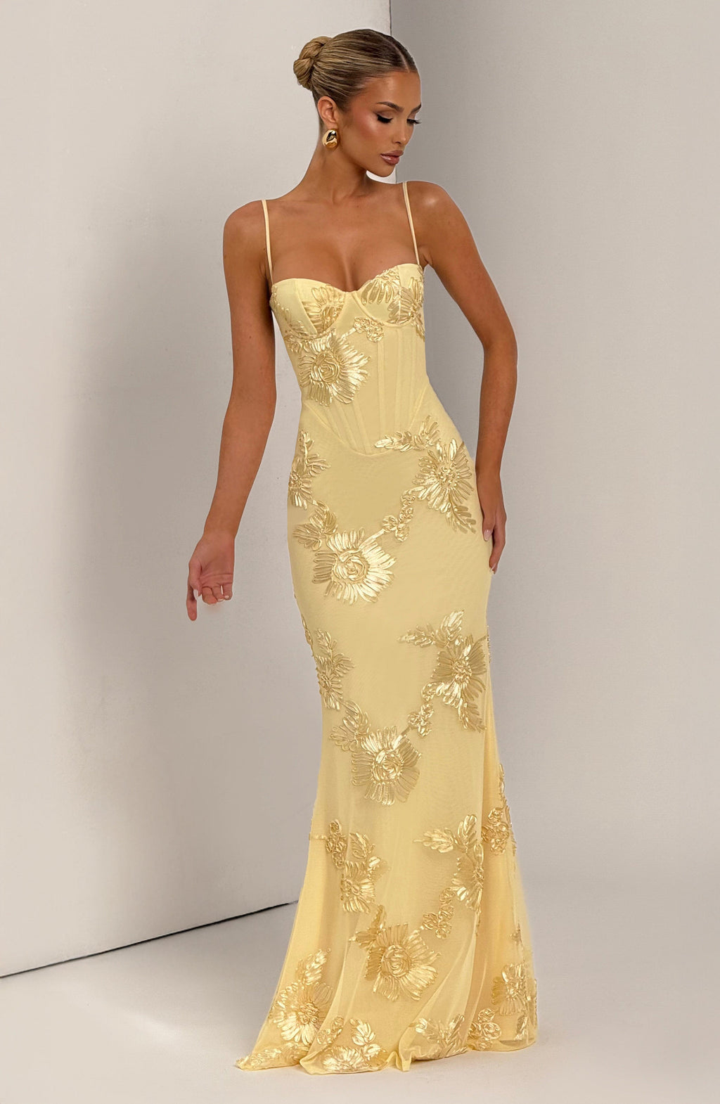Gorgeous mermaid prom dress with floral appliqué and corset top. Elegant maxi gown for a memorable special occasion.