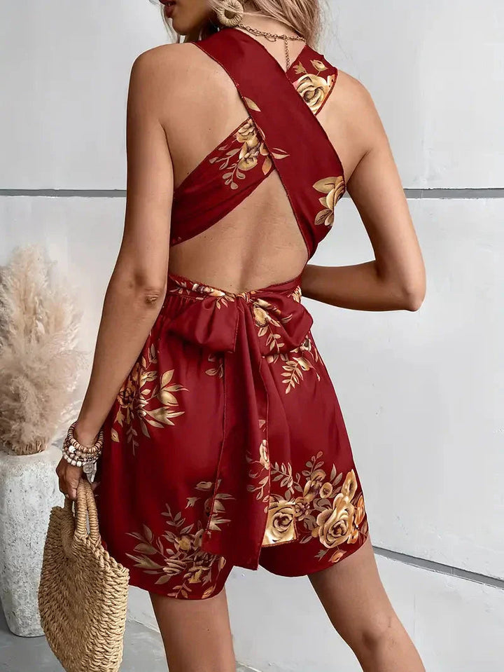 Women's mini dress style floral romper, featuring a fashionable open back and halter neck design.
