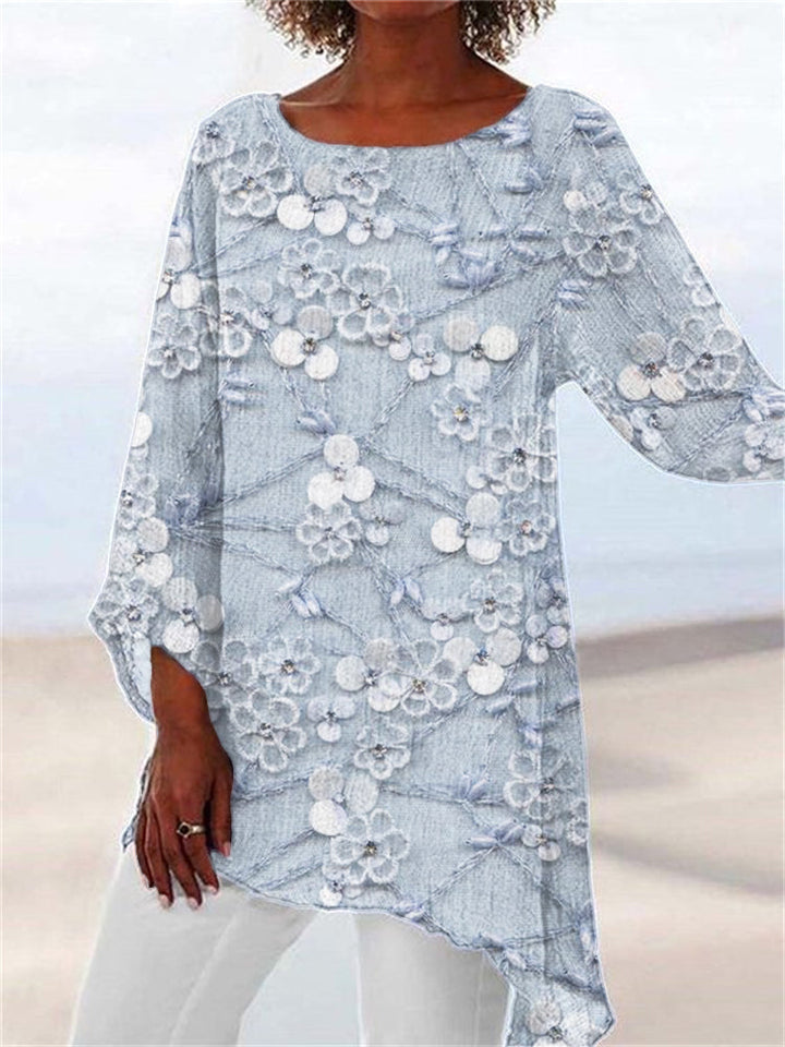 Chic women's embroidered floral tunic top with an asymmetrical hem, versatile for everyday or casual elegant style.