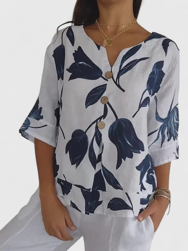 Fashionable women's floral V-neck blouse, ideal for spring and summer. Features elegant print & comfortable long sleeves.
