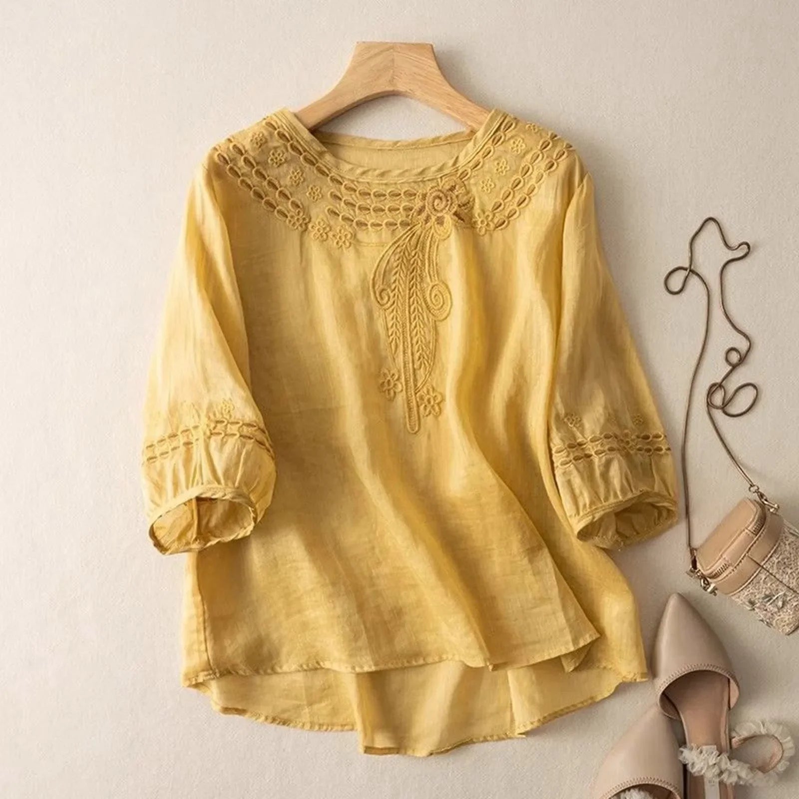 Comfortable relaxed fit women's blouse with elegant floral stitching, a chic versatile top for spring.