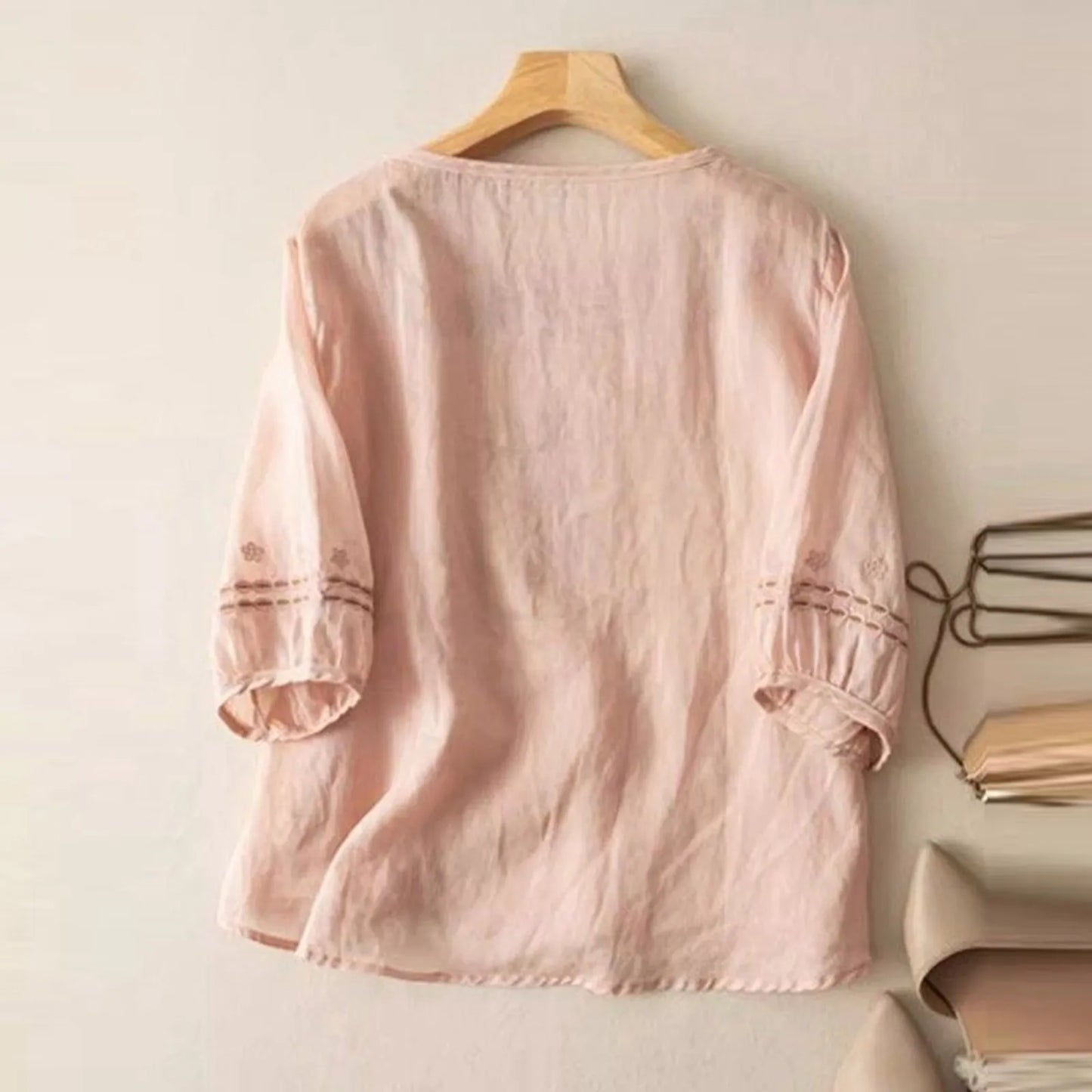 Chic women's blouse with elegant floral stitch design, relaxed fit, a must-have for spring fashion.