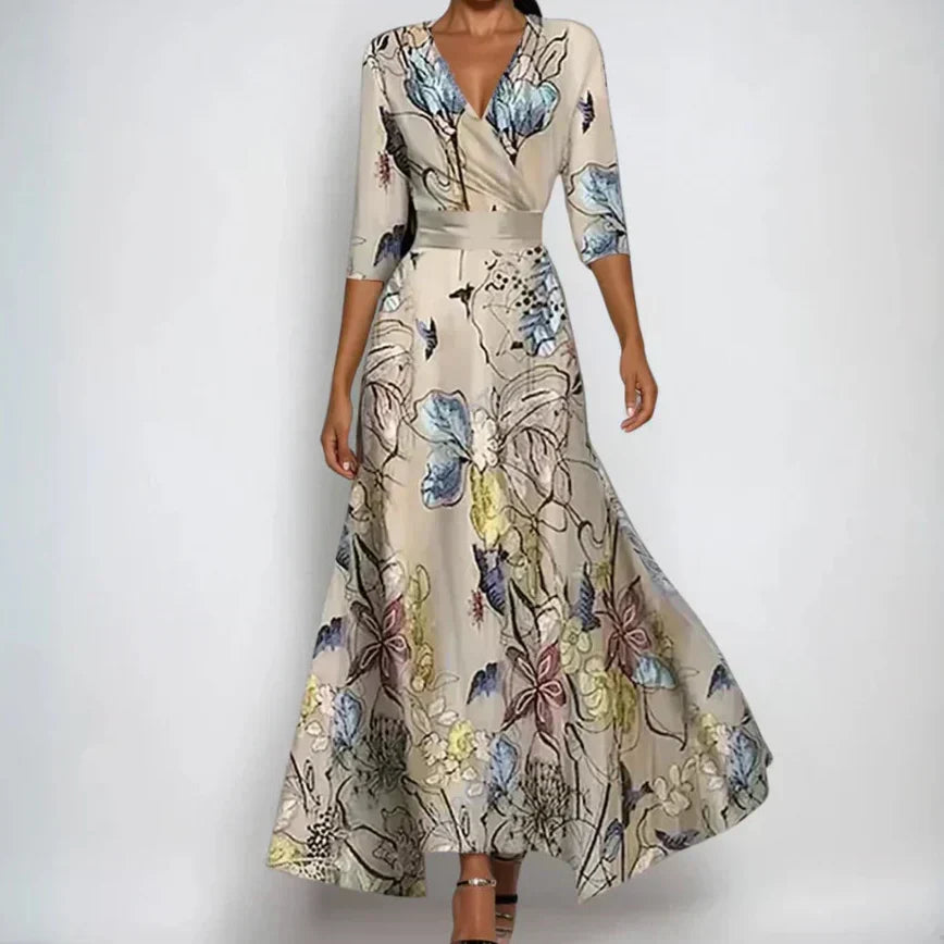Close-up of elegant women's floral wrap dress. Beautiful patterned midi dress with flattering three-quarter sleeves.