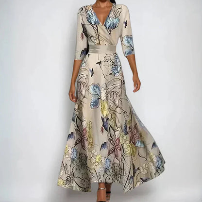 Close-up of elegant women's floral wrap dress. Beautiful patterned midi dress with flattering three-quarter sleeves.