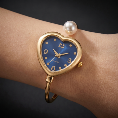Fashionable women's gold bracelet watch featuring shimmering pearl details and a stylish heart accent.