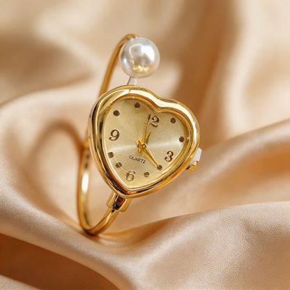 Modern women's bracelet watch: gold tone, pearl accents & a charming heart design, perfect for daily wear.