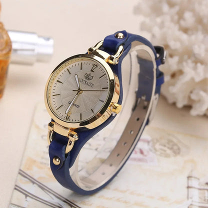 Minimalist women's fashion watch, gold case, white dial, and stylish brown vegan leather band.