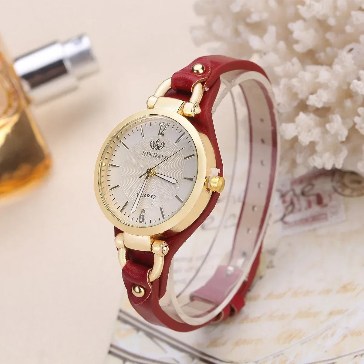 Luxury women's quartz timepiece featuring a gold-tone case and a durable vegan leather strap.