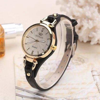 Sophisticated women's gold quartz watch with a striking blue vegan leather strap. Elegant timepiece.