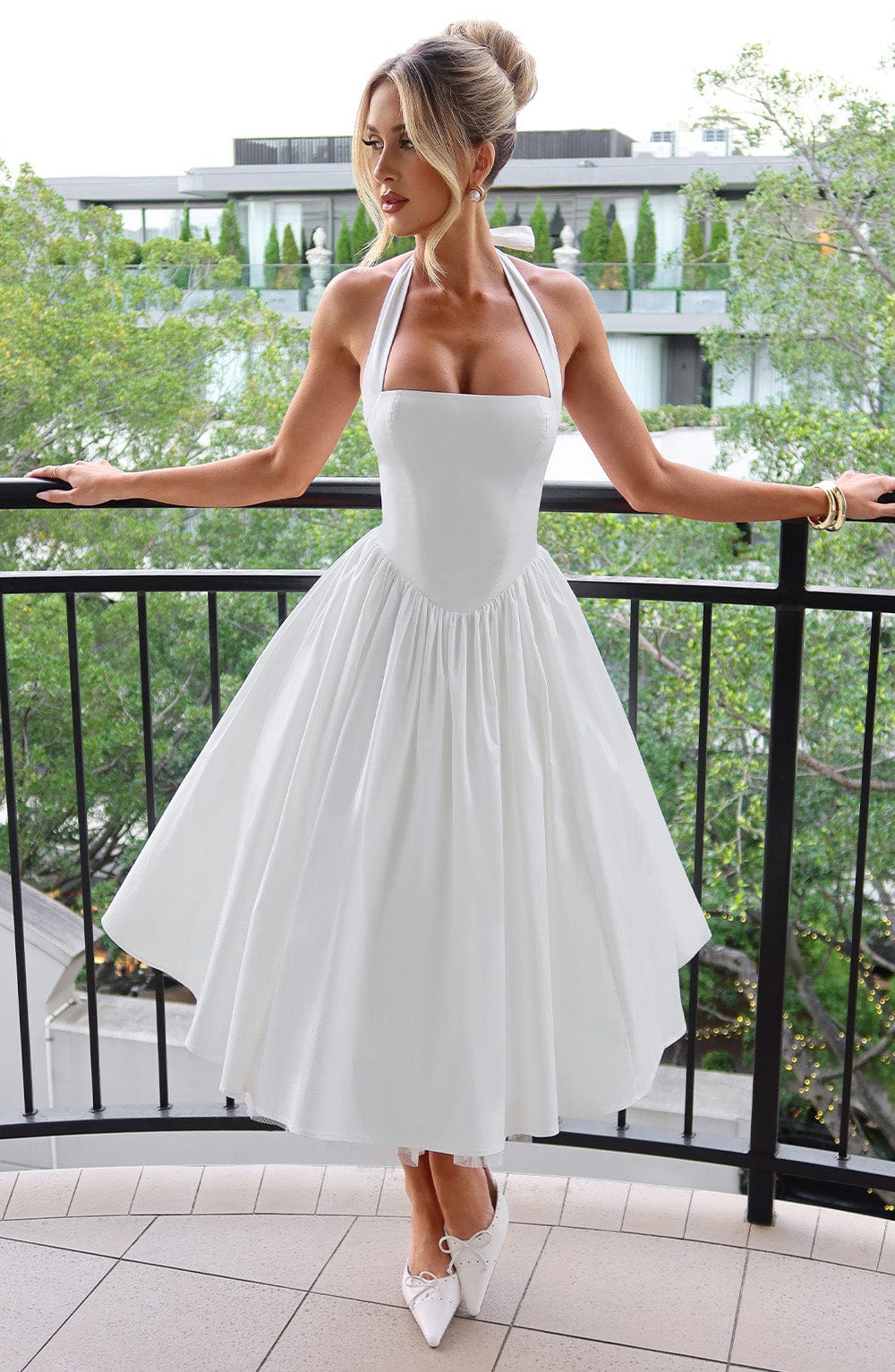 Women's elegant halter neck midi cocktail dress, perfect for sophisticated evening wear.