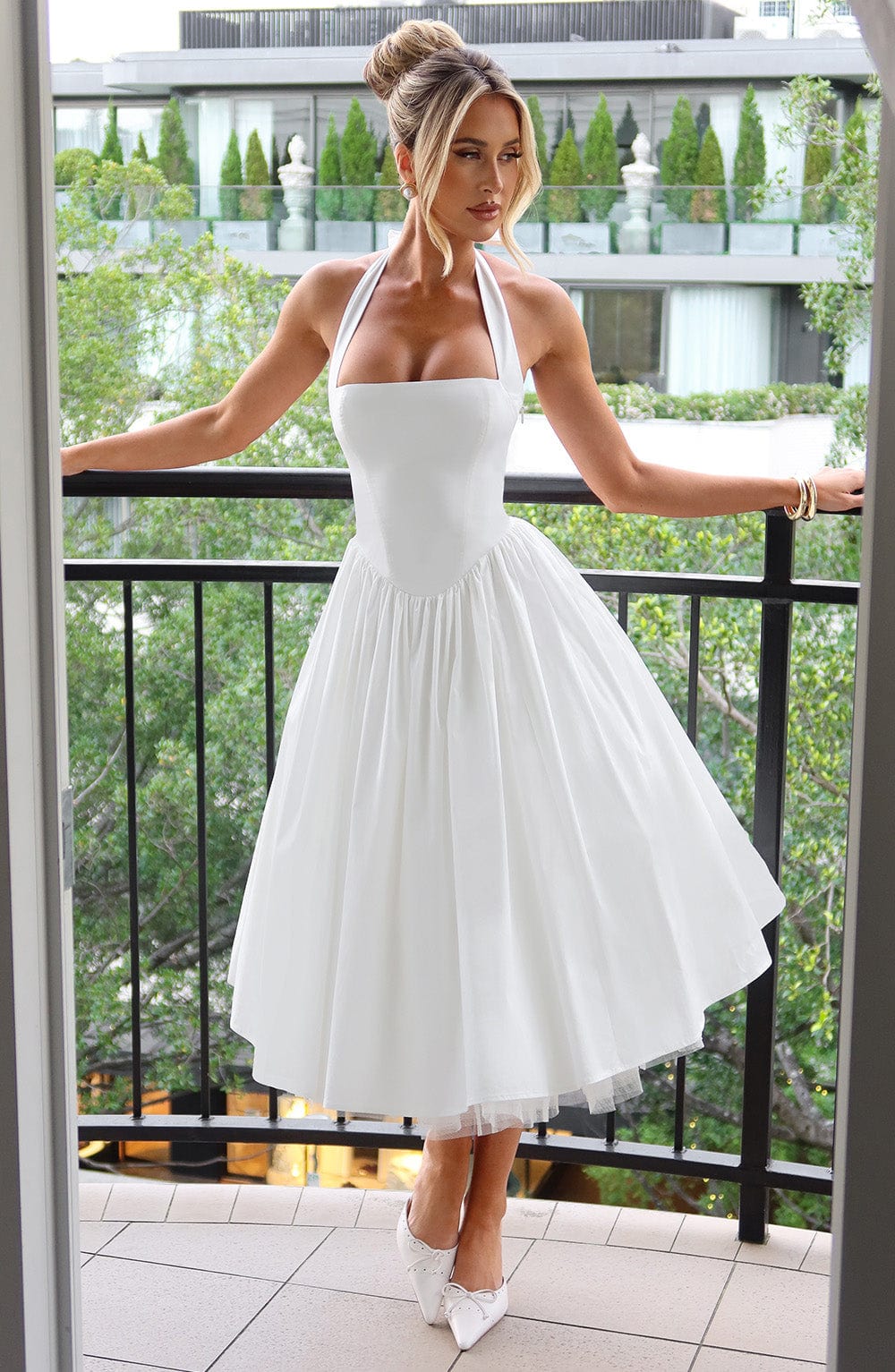 Sophisticated women's halter neck midi dress with a flared skirt, ideal for parties & events.