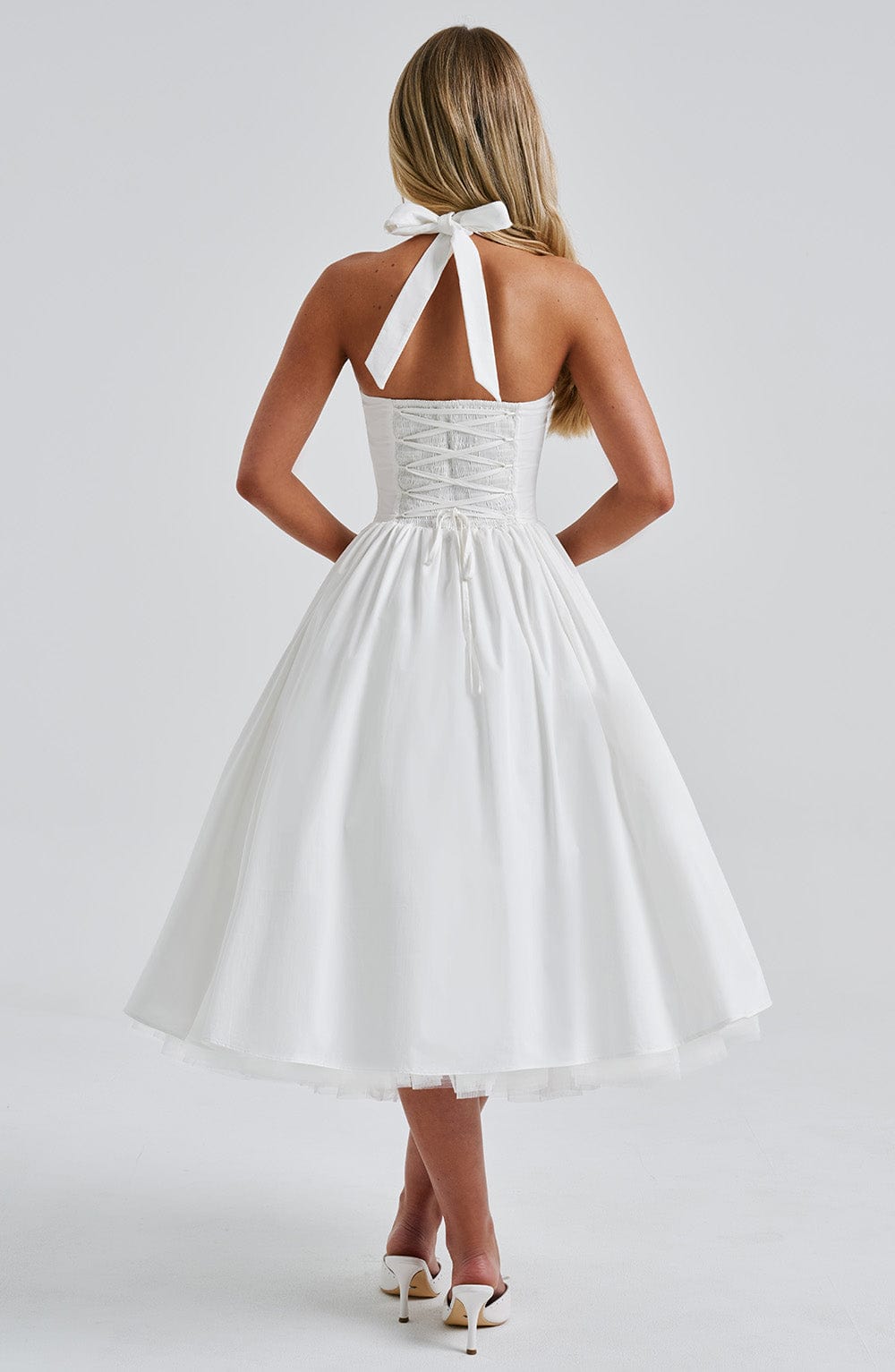 Flared midi halter neck cocktail dress for women, offering a sophisticated and timeless look.