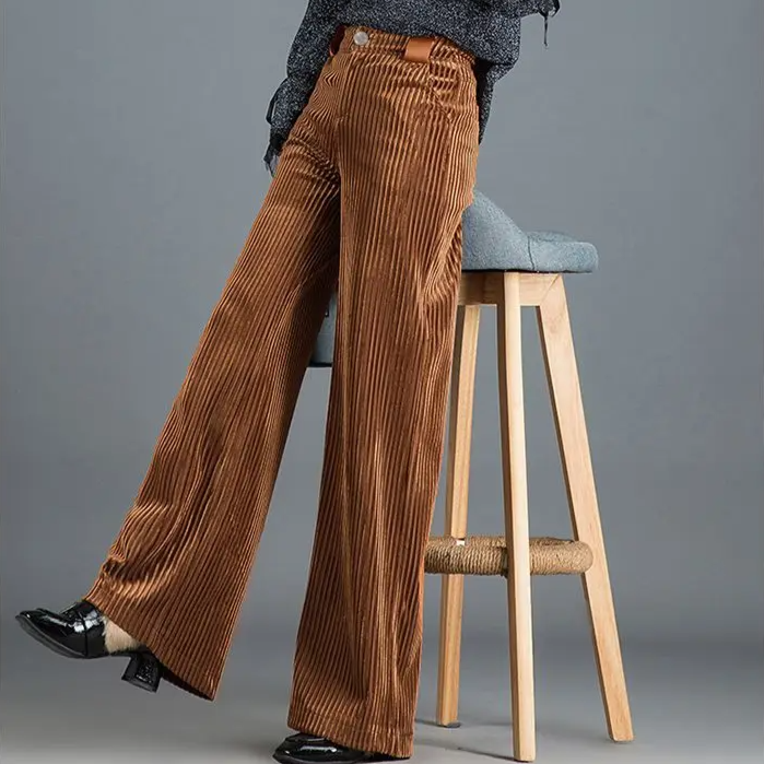 Woman models elegant high-waist wide-leg trousers, showcasing their flowy, versatile fashion appeal.