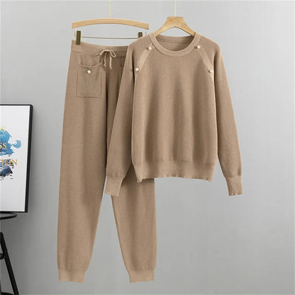 Matching women's pearl-embellished knit sweater and jogger set. Cozy two-piece loungewear for comfortable and stylish casual wear.