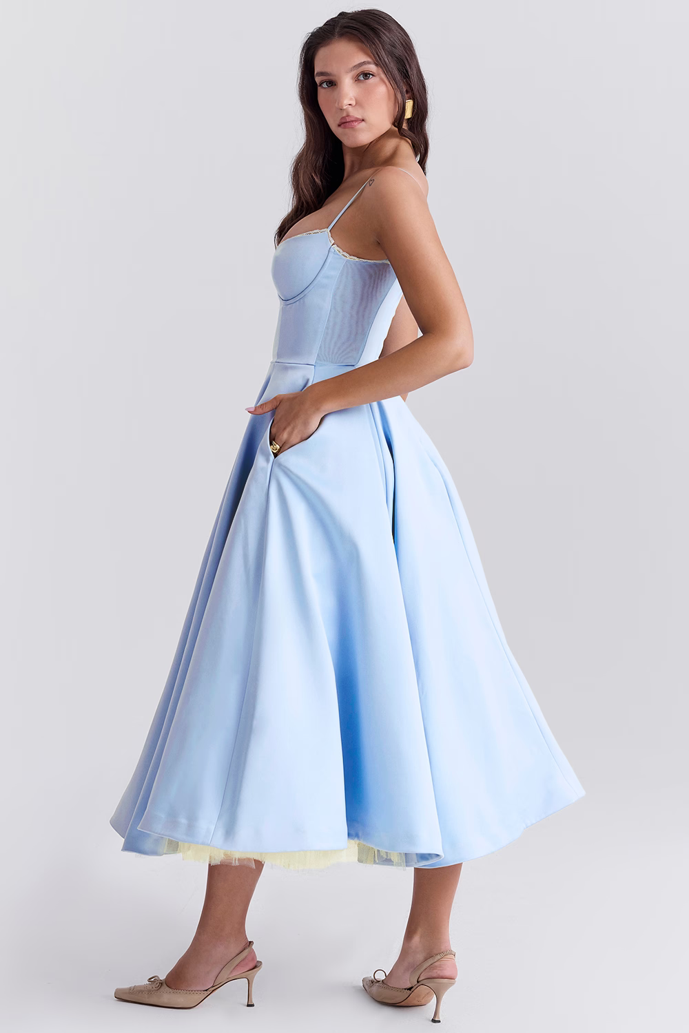 Sleeveless midi dress with a flattering corset bodice, sweetheart neckline, elegant lace trim, and practical pockets.