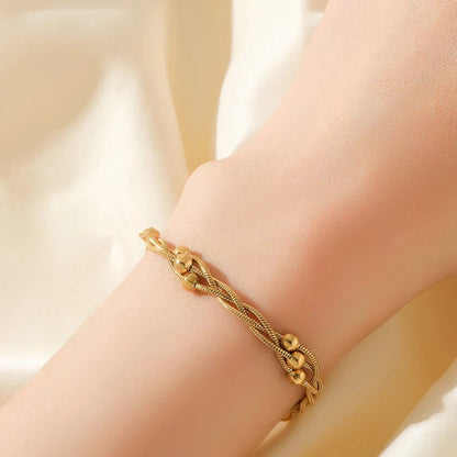 Stylish gold-tone layered chain bracelet for women, made from durable stainless steel jewelry.