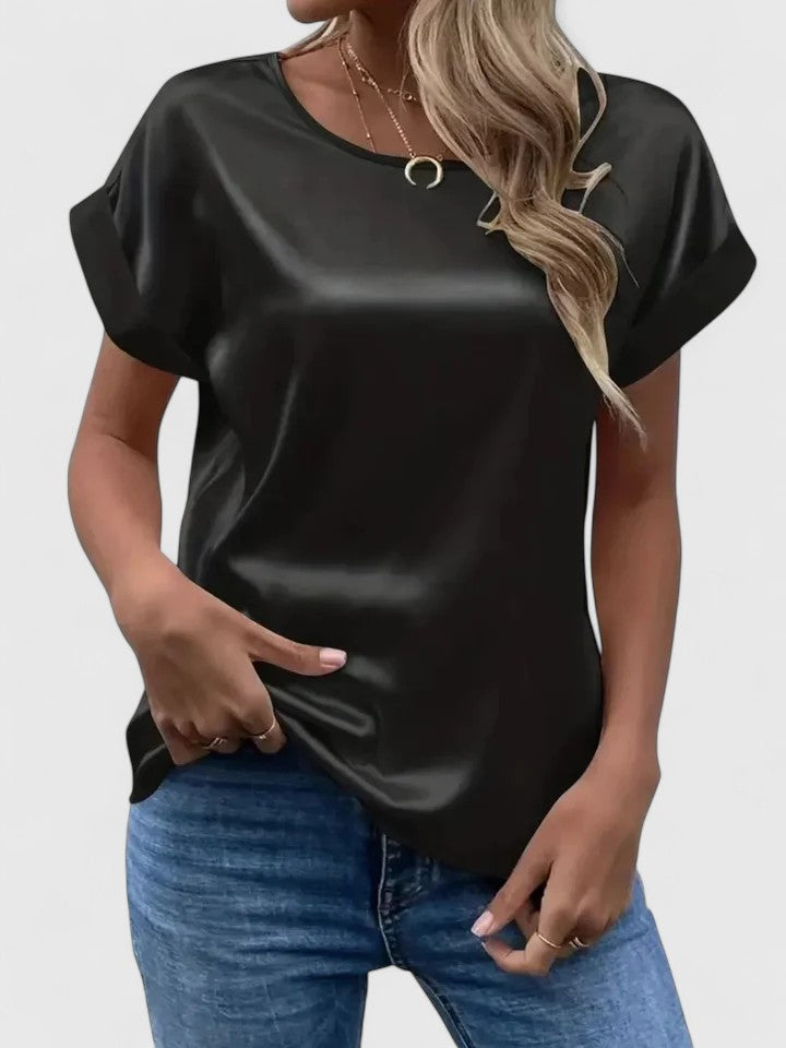 Relaxed comfort women's batwing blouse, versatile for summer fashion or elegant office wear. Loose fit top.