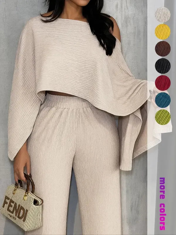 Stylish women's pleated one-shoulder top and wide-leg trousers coordinated set, perfect for spring/summer outfit.