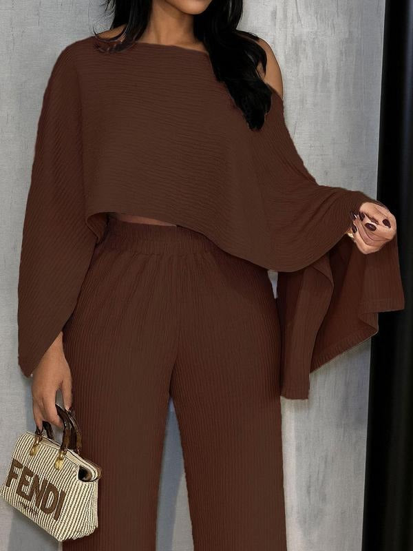 Women's summer two-piece outfit: pleated one-shoulder top & comfortable wide-leg pants for a sophisticated look.