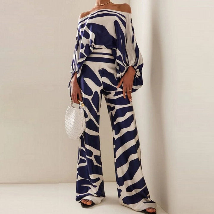 Women's two-piece one-shoulder abstract print pants set, flowy & chic, great for elegant summer or resort wear.