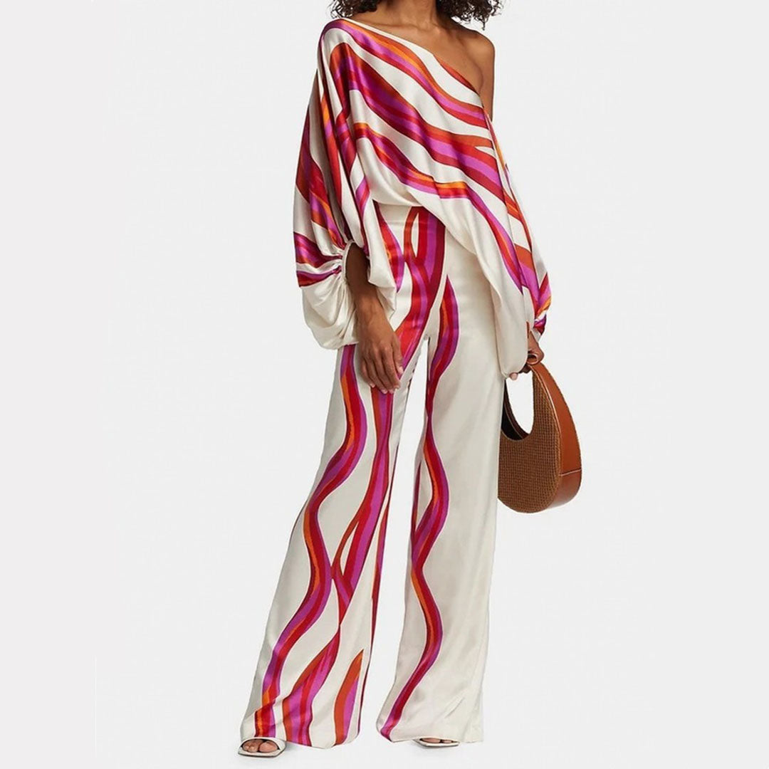 Chic women's one-shoulder top & flowy printed pants set, abstract design, perfect vacation outfit or summer fashion.