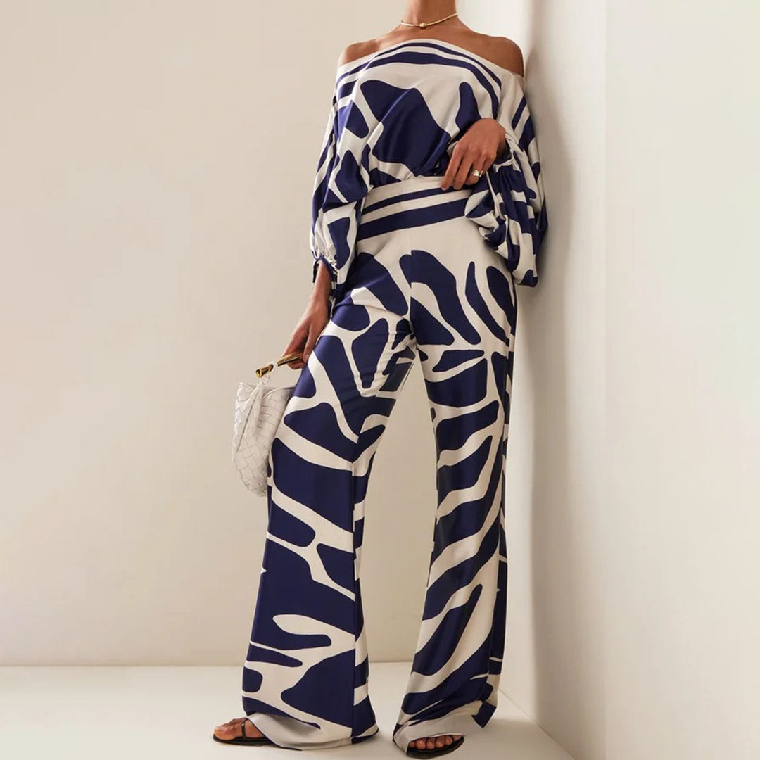 Flowy women's one-shoulder abstract print two-piece set, perfect for elegant summer fashion or stylish resort wear.