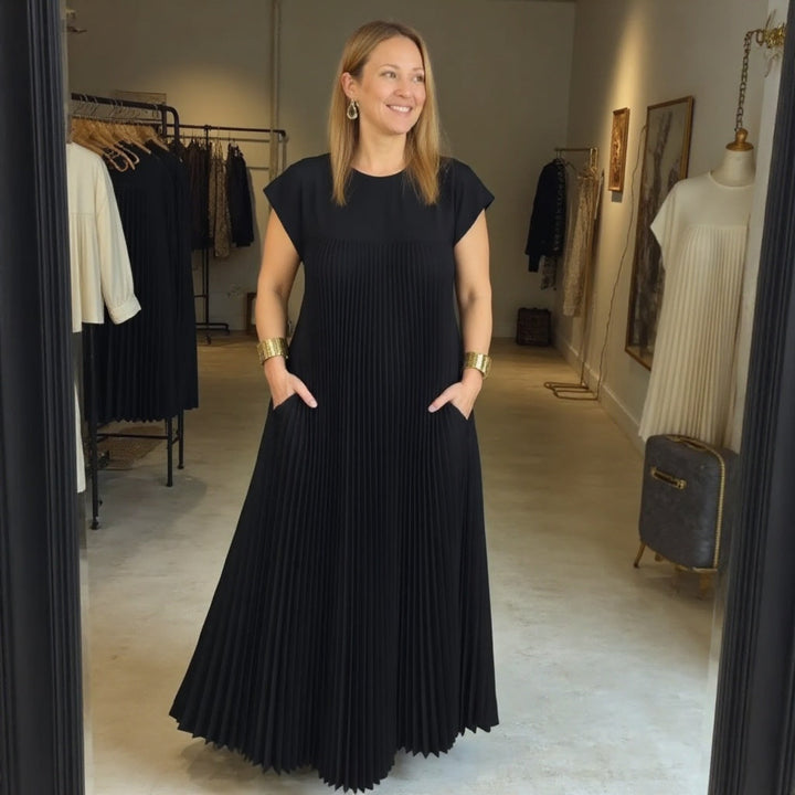 Graceful women's pleated maxi dress, designed with a flowing skirt for elegant movement and comfort.