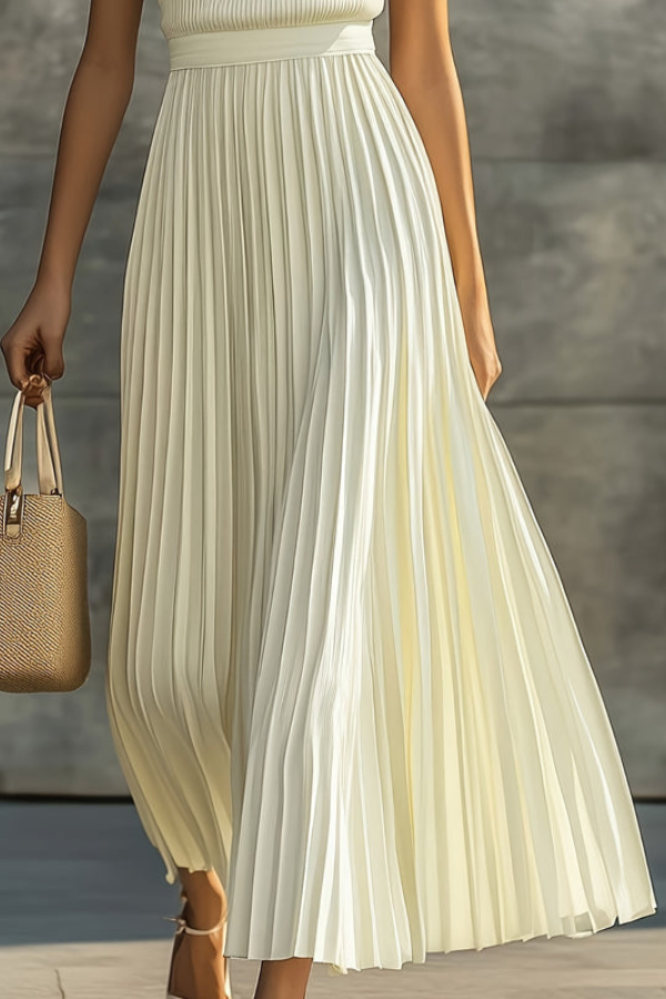 Women's comfortable sleeveless pleated midi dress, offering elegant style for any summer occasion or resort wear.
