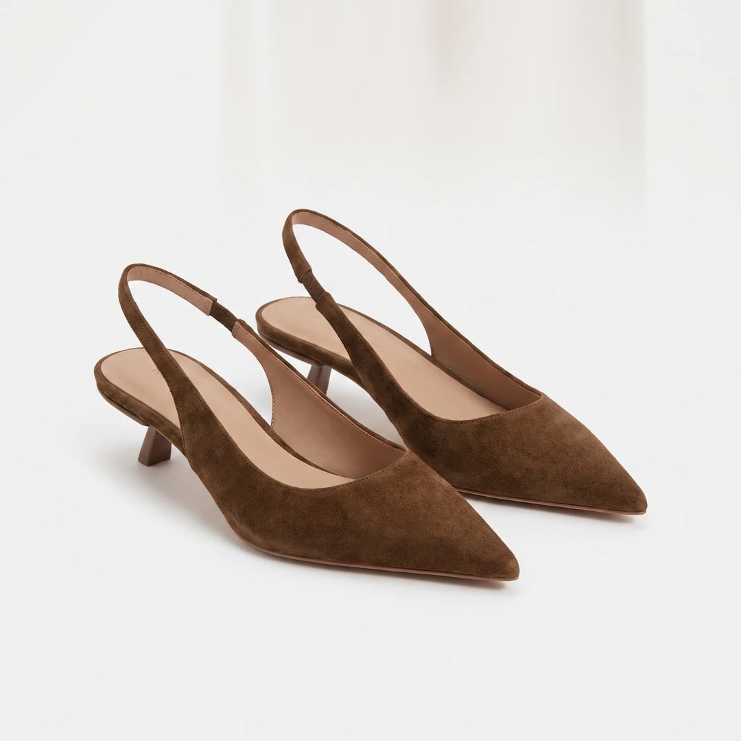 Close-up of women's pointed-toe kitten heel slingback sandals, showcasing elegant design & strap.