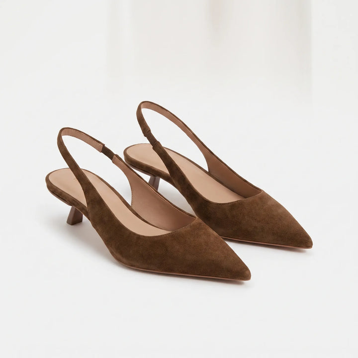 Close-up of women's pointed-toe kitten heel slingback sandals, showcasing elegant design & strap.