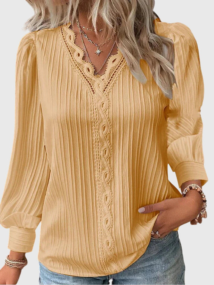 Women's elegant pullover blouse with long sleeves & round neck, perfect for work or casual chic style.