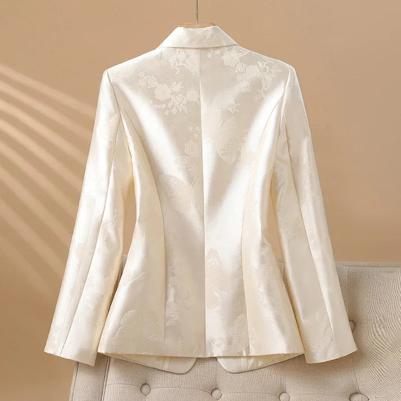 Sophisticated women's rosette jacket with a standout jeweled button, perfect for elegant occasion wear.
