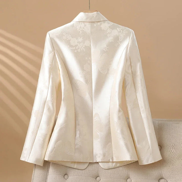 Sophisticated women's rosette jacket with a standout jeweled button, perfect for elegant occasion wear.