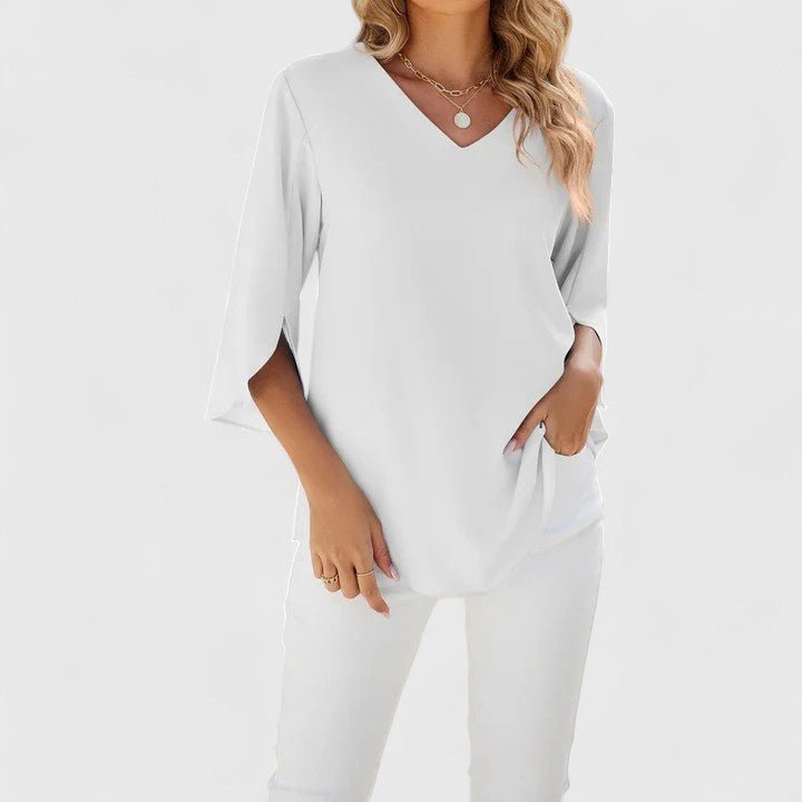 Flowy women's blouse, featuring a V-neck, ruffles, and stylish split sleeves for comfort.