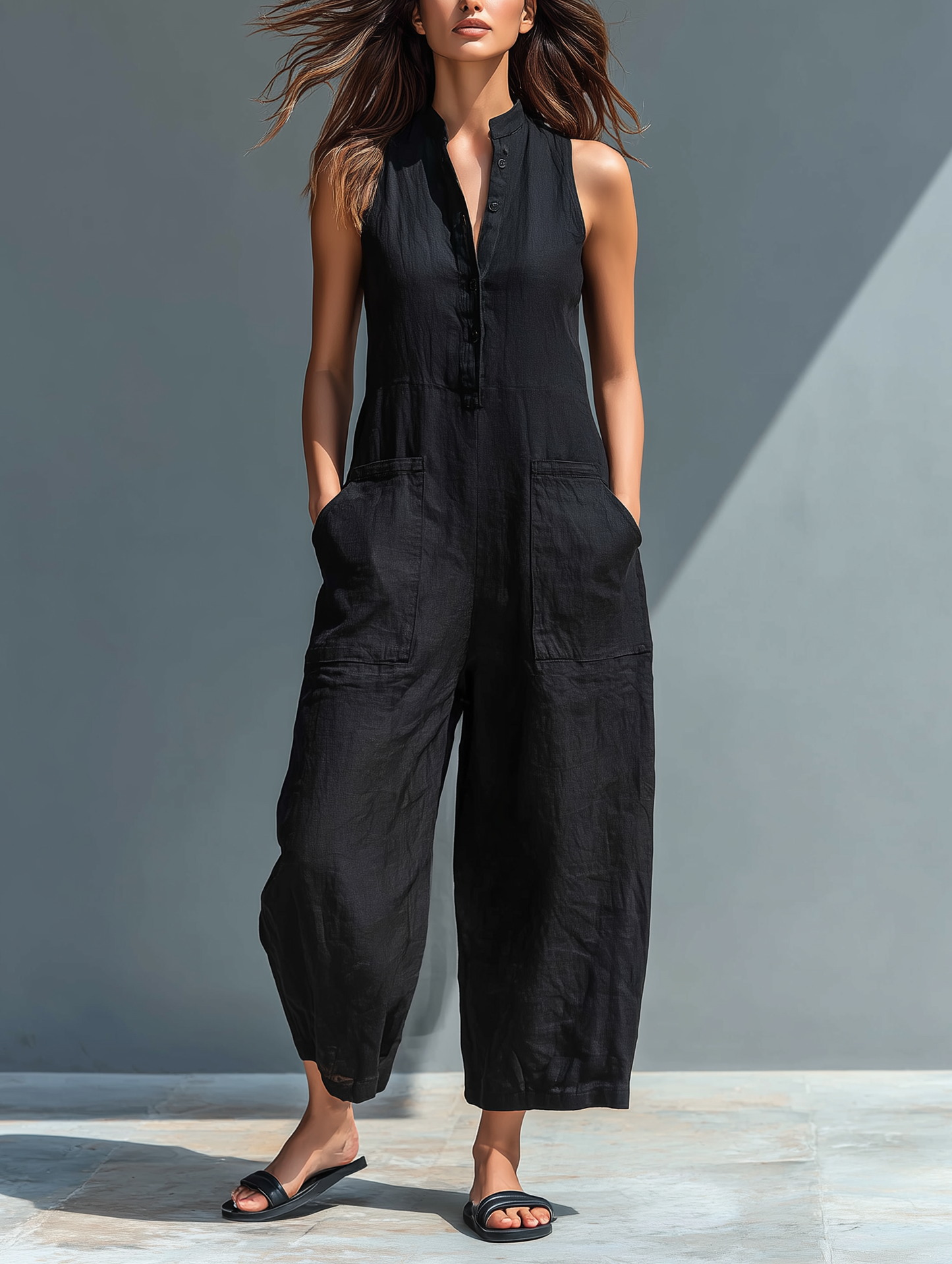 Women's elegant sleeveless jumpsuit with mandarin collar & button front. Chic & versatile for summer resort wear.