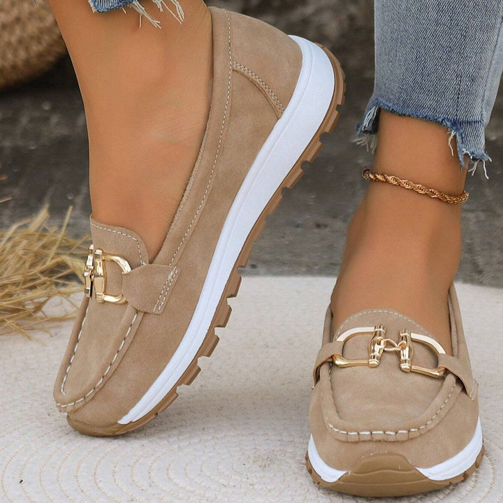 Women's elegant slip-on loafers with a stylish gold buckle, perfect for comfort and versatility.