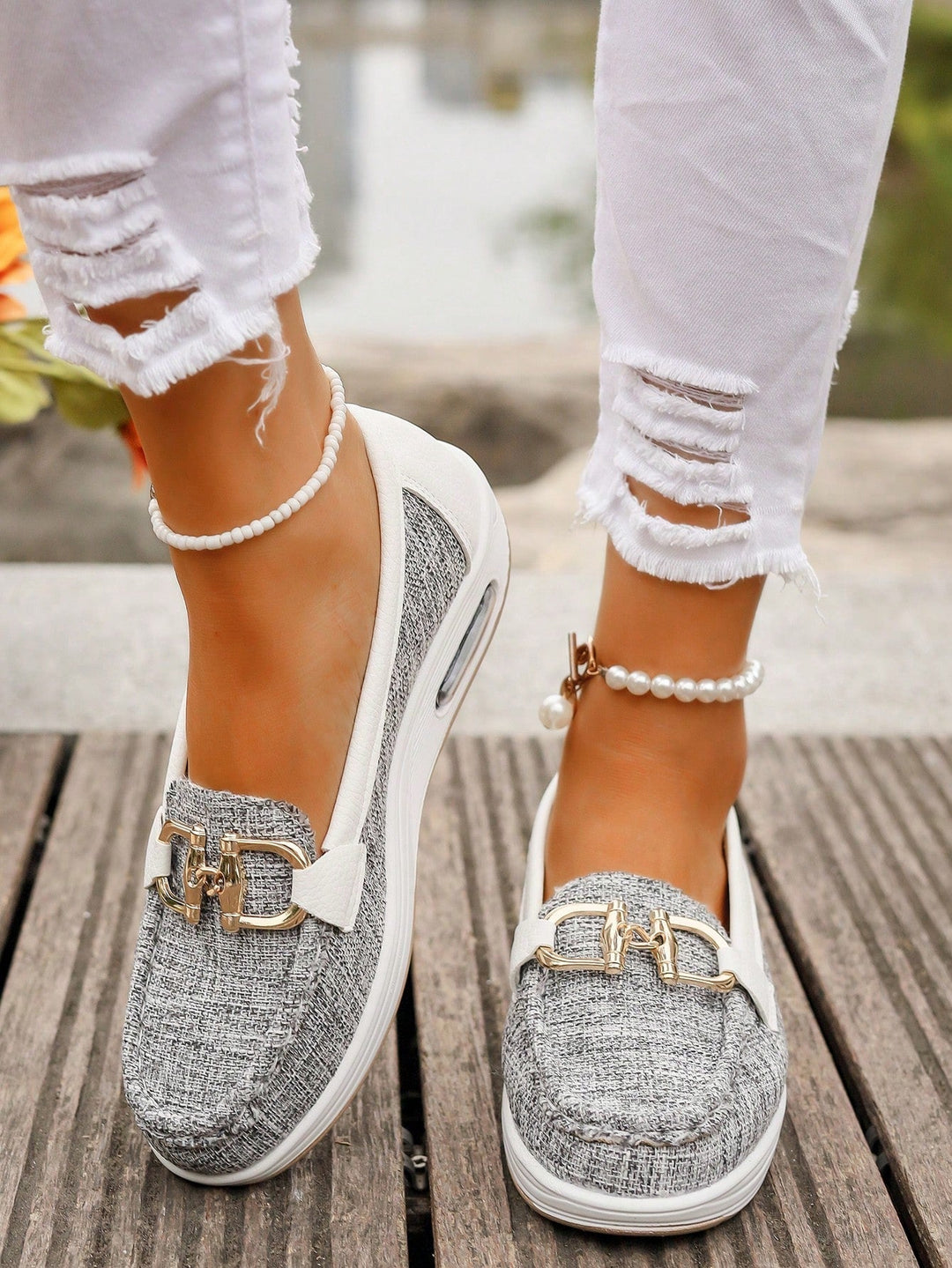 Trendy women's fashion loafers, slip-on style, featuring a prominent gold buckle and ultimate comfort.