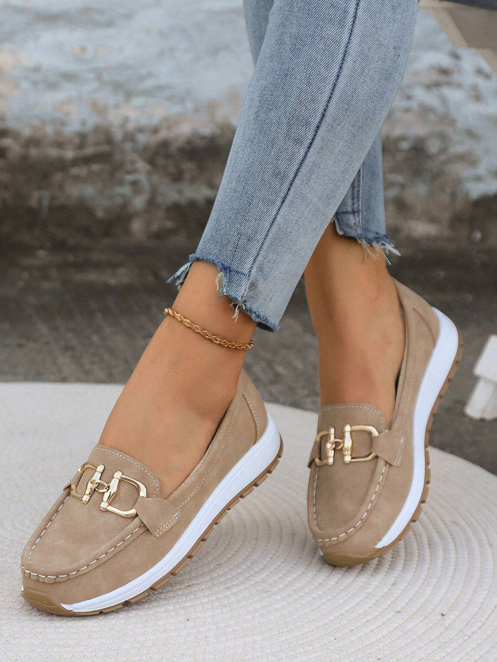 Comfortable women's flat loafers featuring a chic gold buckle, ideal for casual or work wear.