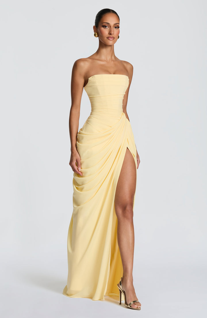 Yellow strapless maxi dress with a structured corset bodice, ideal for a party or elegant evening wear.