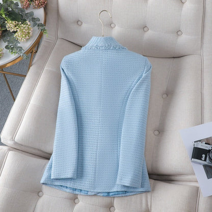 Structured women's jacket with long sleeves and elegant pearl buttons, offering a sharp, modern classic look.