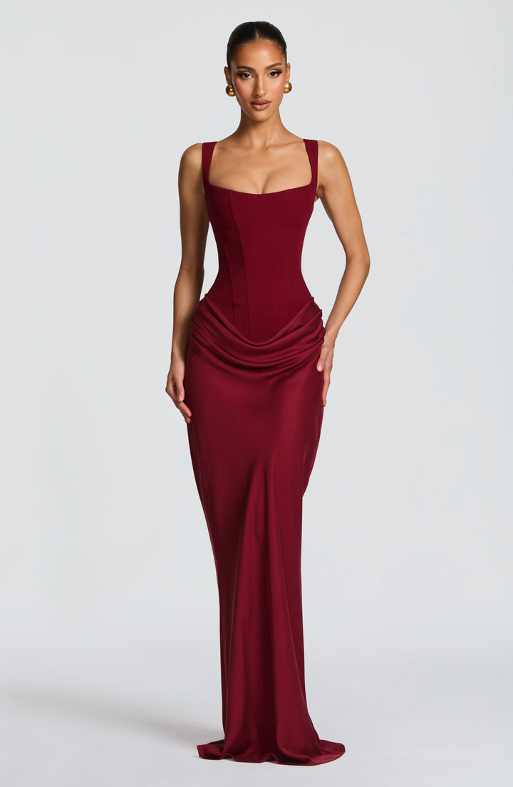 Women's elegant structured corset bodice maxi dress with draped skirt, perfect for formal evening events.