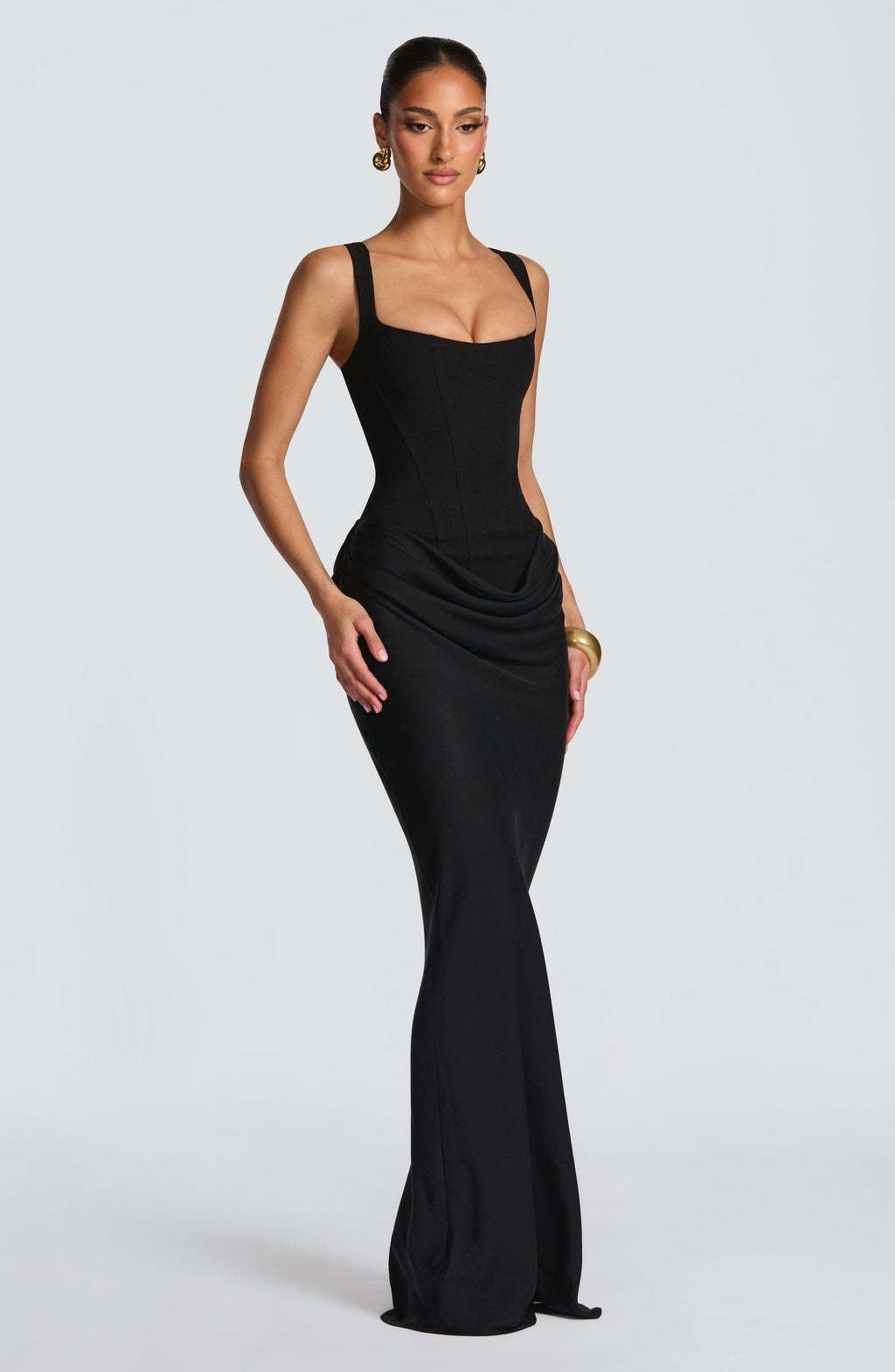 Floor-length women's formal corset dress. An elegant evening gown with a structured top and flowing skirt.