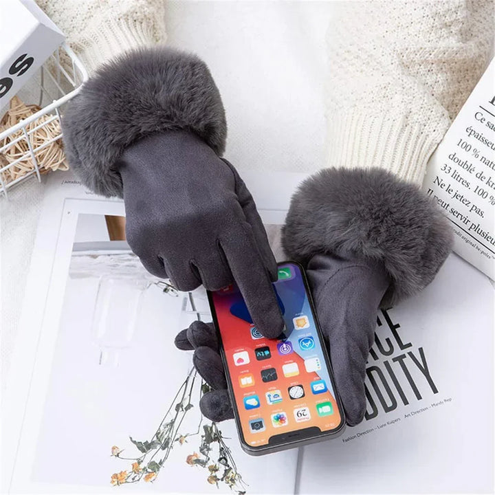 Smooth suede women's gloves with fluffy faux fur trim, providing comfort and warmth.