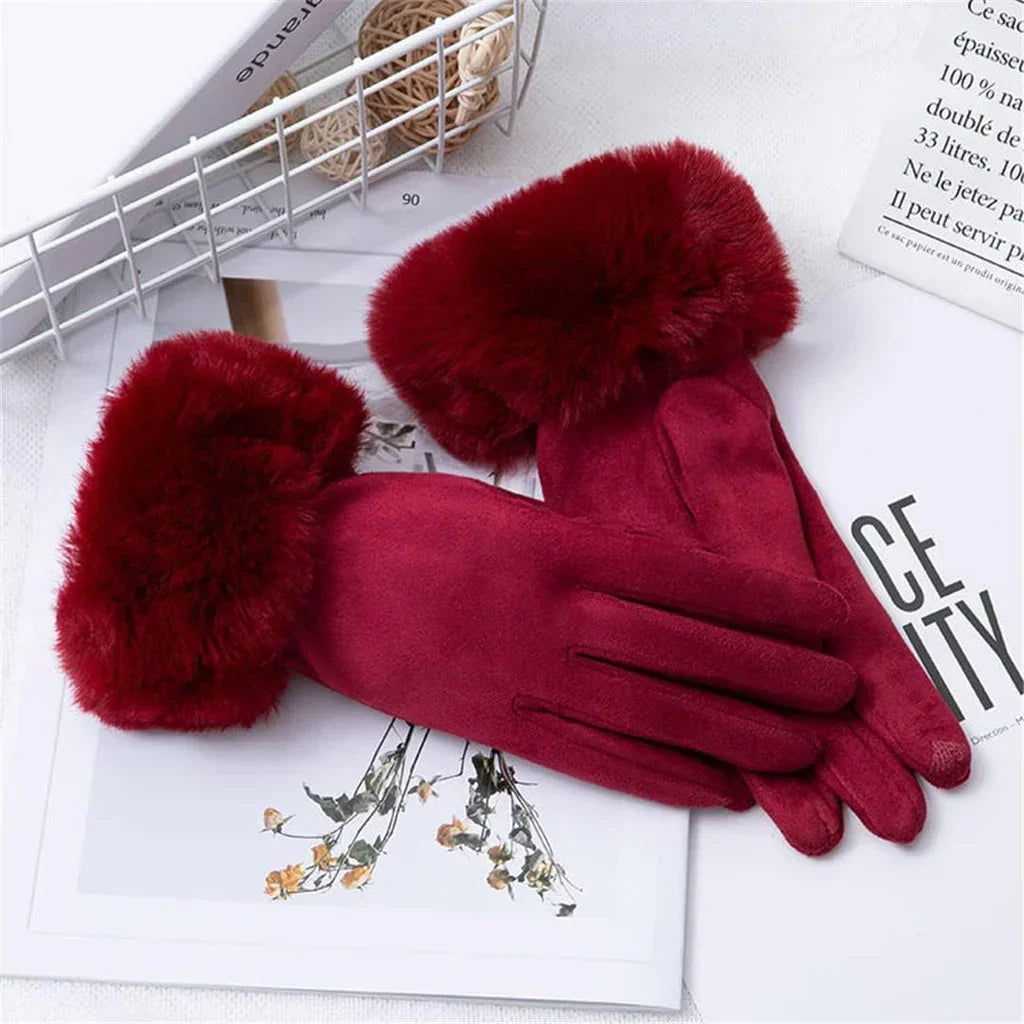 Warm women's suede gloves with luxurious faux fur trim, ideal for cold weather.