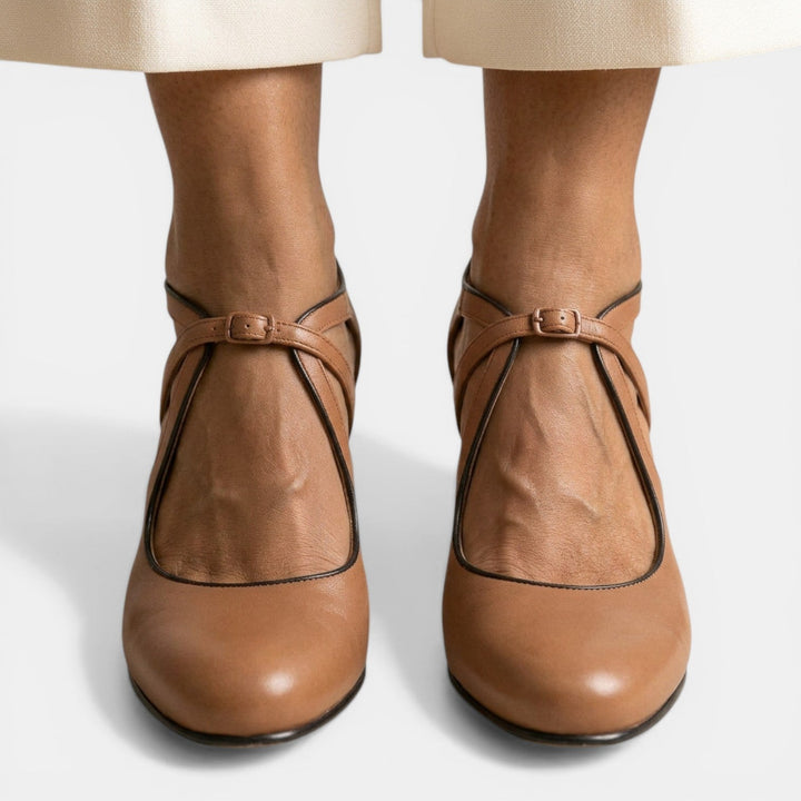 Close-up of women's T-strap high heel sandal, highlighting the adjustable buckle closure & elegant round toe design.
