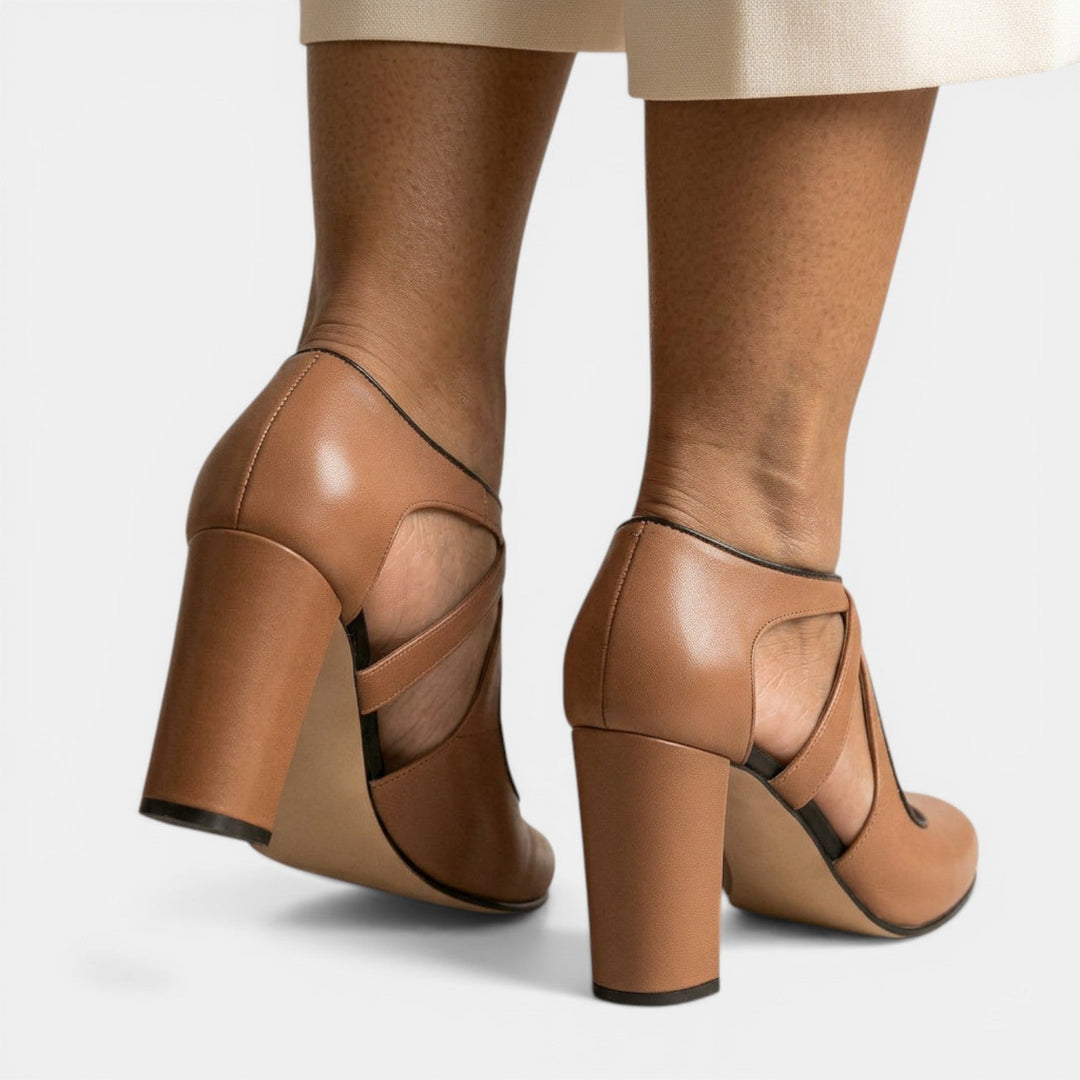 Side view of sleek women's T-strap high heel sandals, showcasing the elegant heel height & classic round toe. Formal.